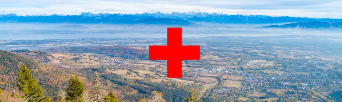 paysage du pays de gex sur lequel on voit le symbole "+" rouge de l'Hopital rouge