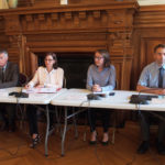 Sont alignés sur des tables les différents acteurs du PDLHIPE, dont Cécile Bigot-Dekeyzer, préfète de l’Ain